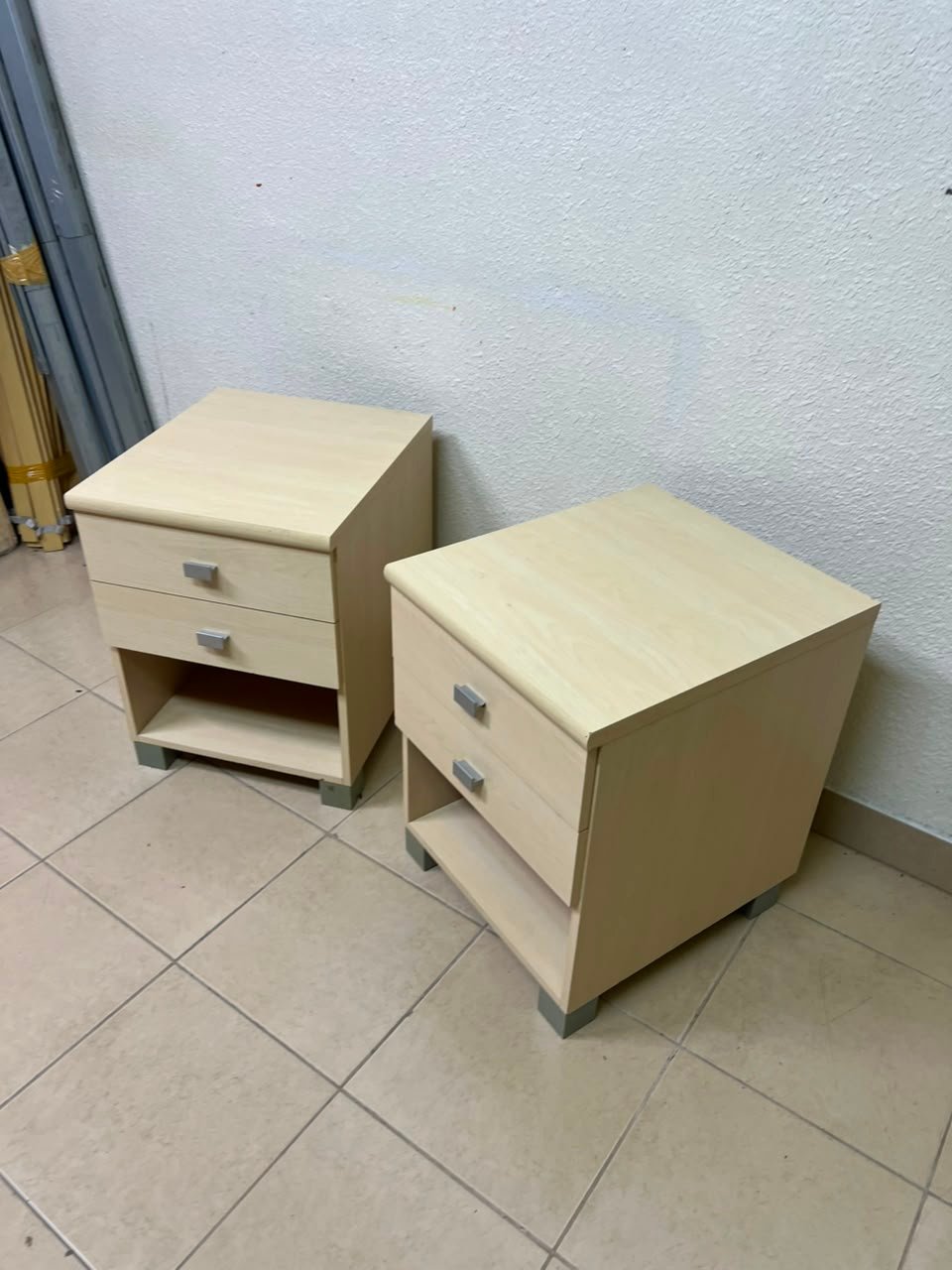 A set of two modern bedside tables in a light wood color with two drawers and open storage space. - Image 10