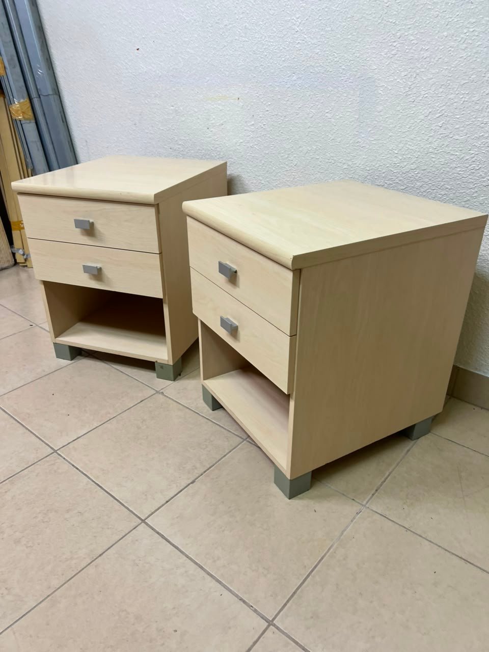 A set of two modern bedside tables in a light wood color with two drawers and open storage space. - Image 9