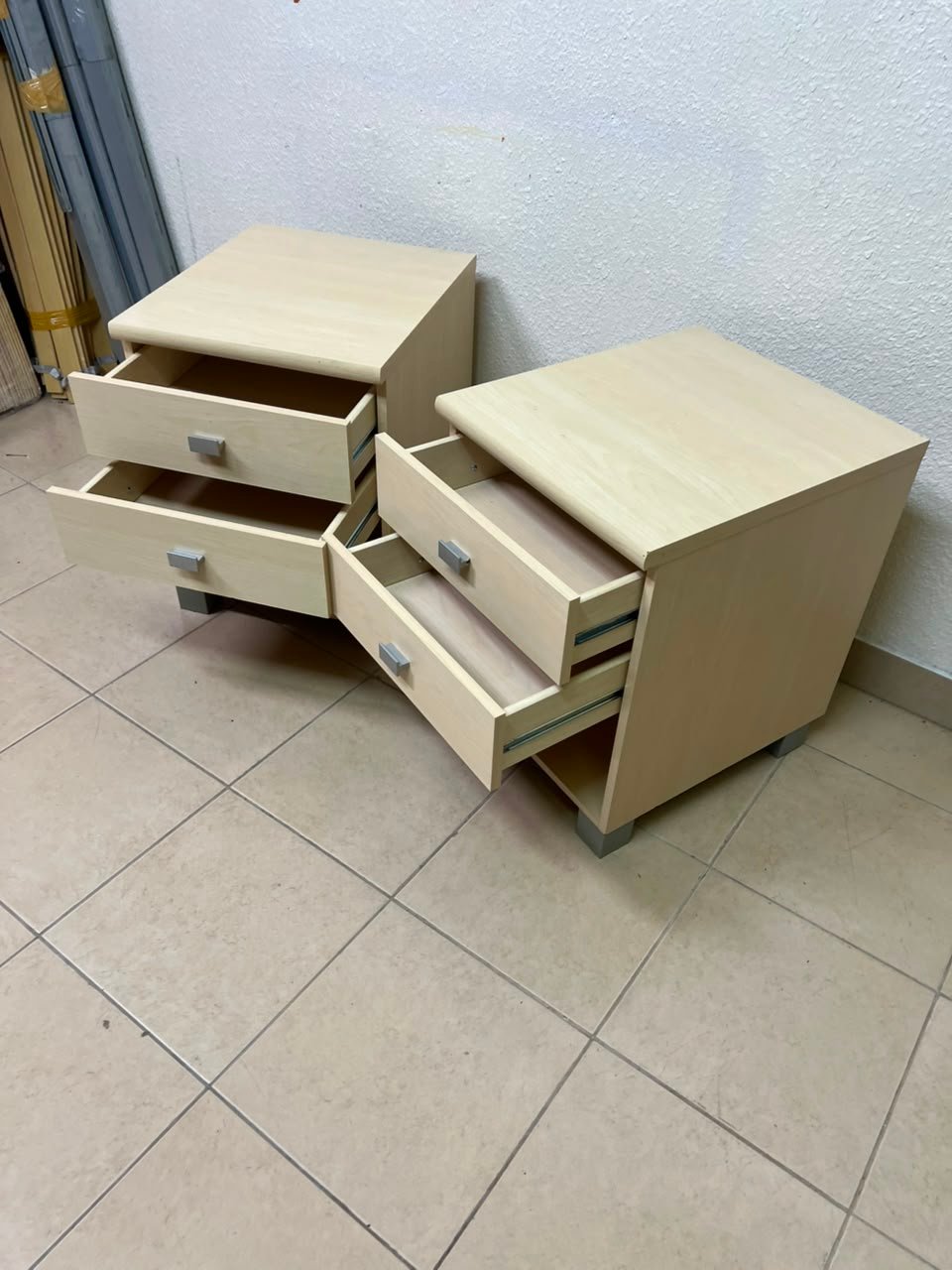 A set of two modern bedside tables in a light wood color with two drawers and open storage space. - Image 2