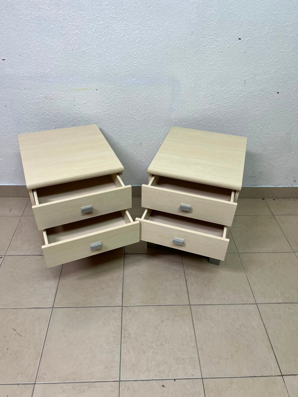 A set of two modern bedside tables in a light wood color with two drawers and open storage space. - Image 12