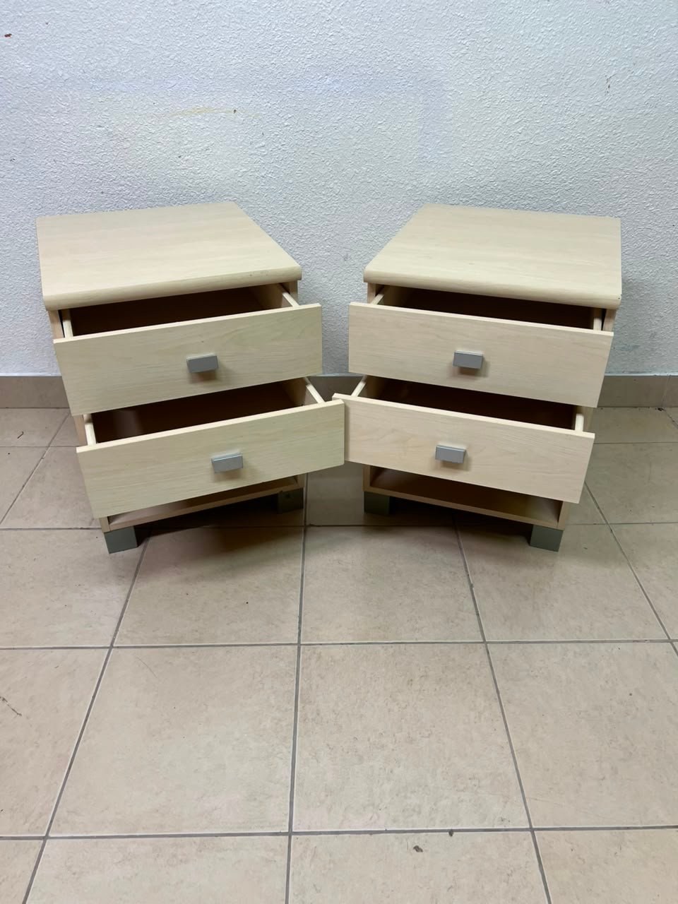 A set of two modern bedside tables in a light wood color with two drawers and open storage space. - Image 14
