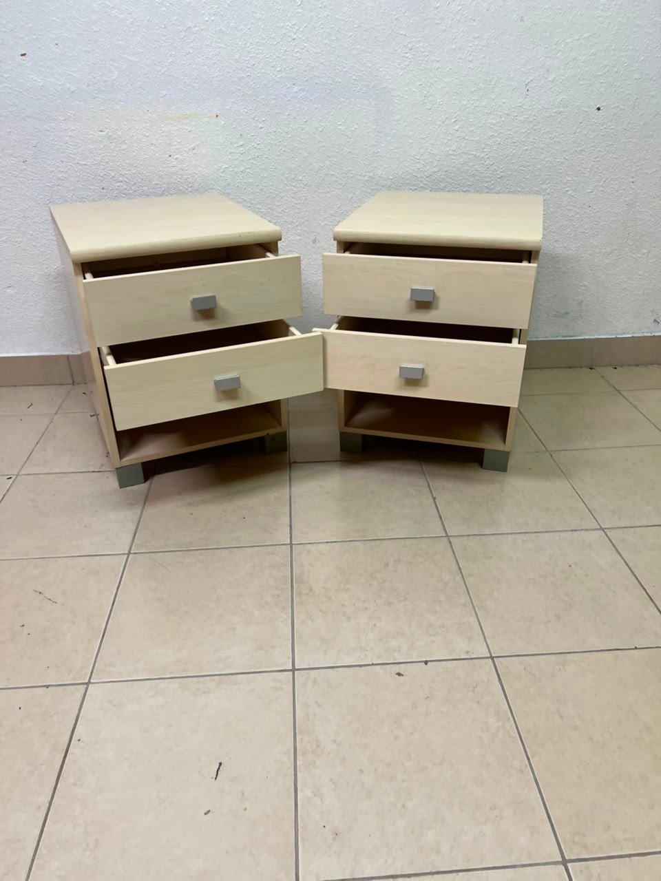 A set of two modern bedside tables in a light wood color with two drawers and open storage space. - Image 11