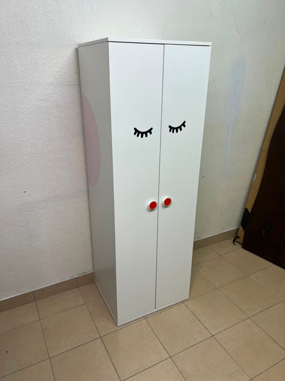 Whimsical Kids' Wardrobe with Sleeping Eyes Design – White 2-Door Storage Cabinet with Red Handles - Image 5