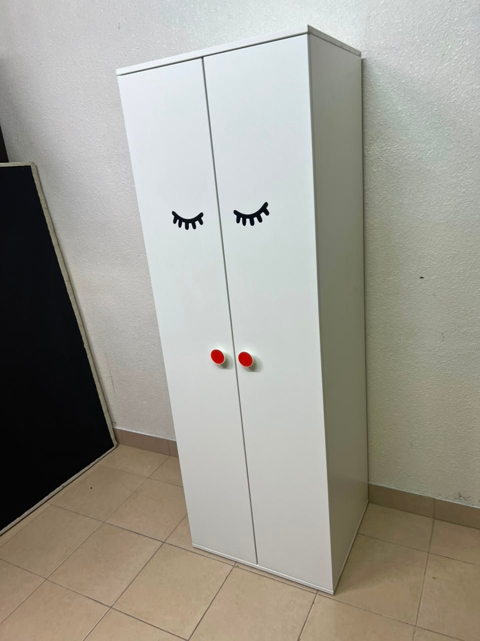 Whimsical Kids' Wardrobe with Sleeping Eyes Design – White 2-Door Storage Cabinet with Red Handles - Image 6