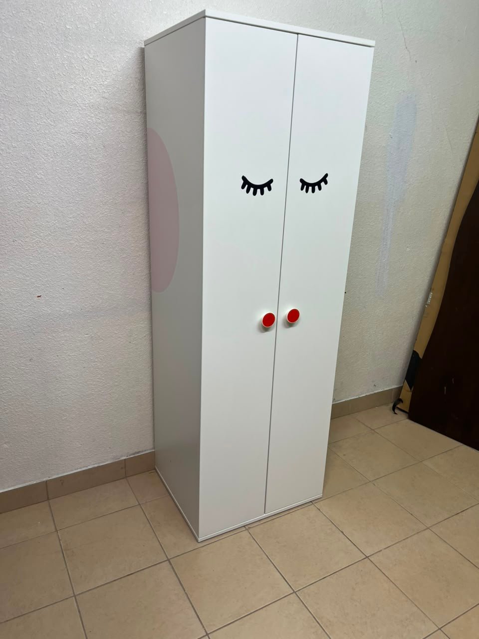 Whimsical Kids' Wardrobe with Sleeping Eyes Design – White 2-Door Storage Cabinet with Red Handles - Image 9