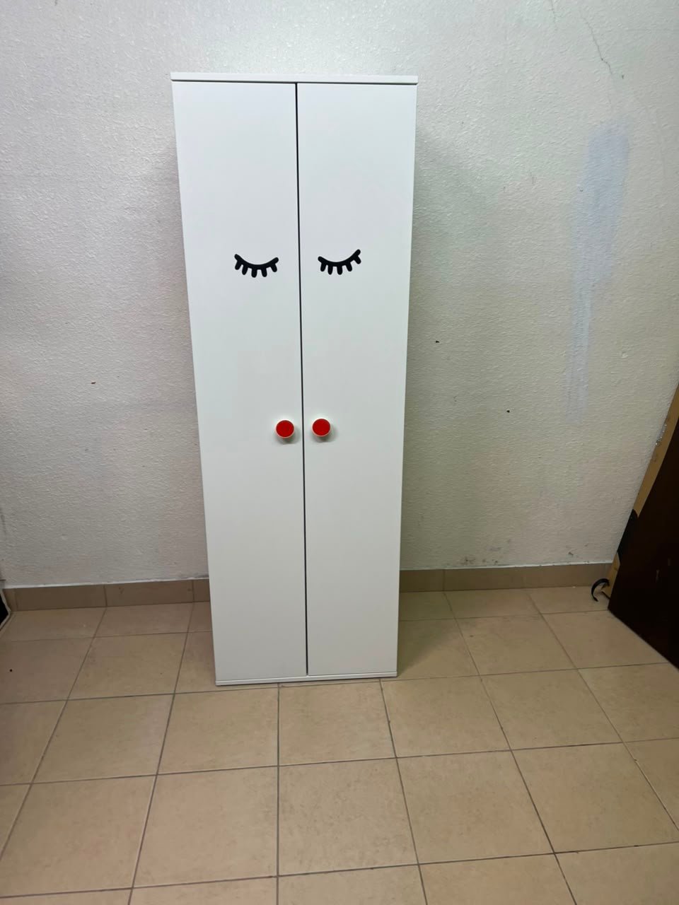 Whimsical Kids' Wardrobe with Sleeping Eyes Design – White 2-Door Storage Cabinet with Red Handles