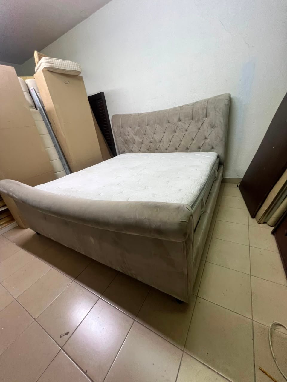 A classic diamond-patterned quilted bed with a mattress featuring soft velvet fabric in beige or gray. - Image 4