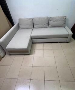 The IKEA FRIHETEN corner sofa that converts into a bed features a light gray color and a practical design that includes storage space. - Image 10