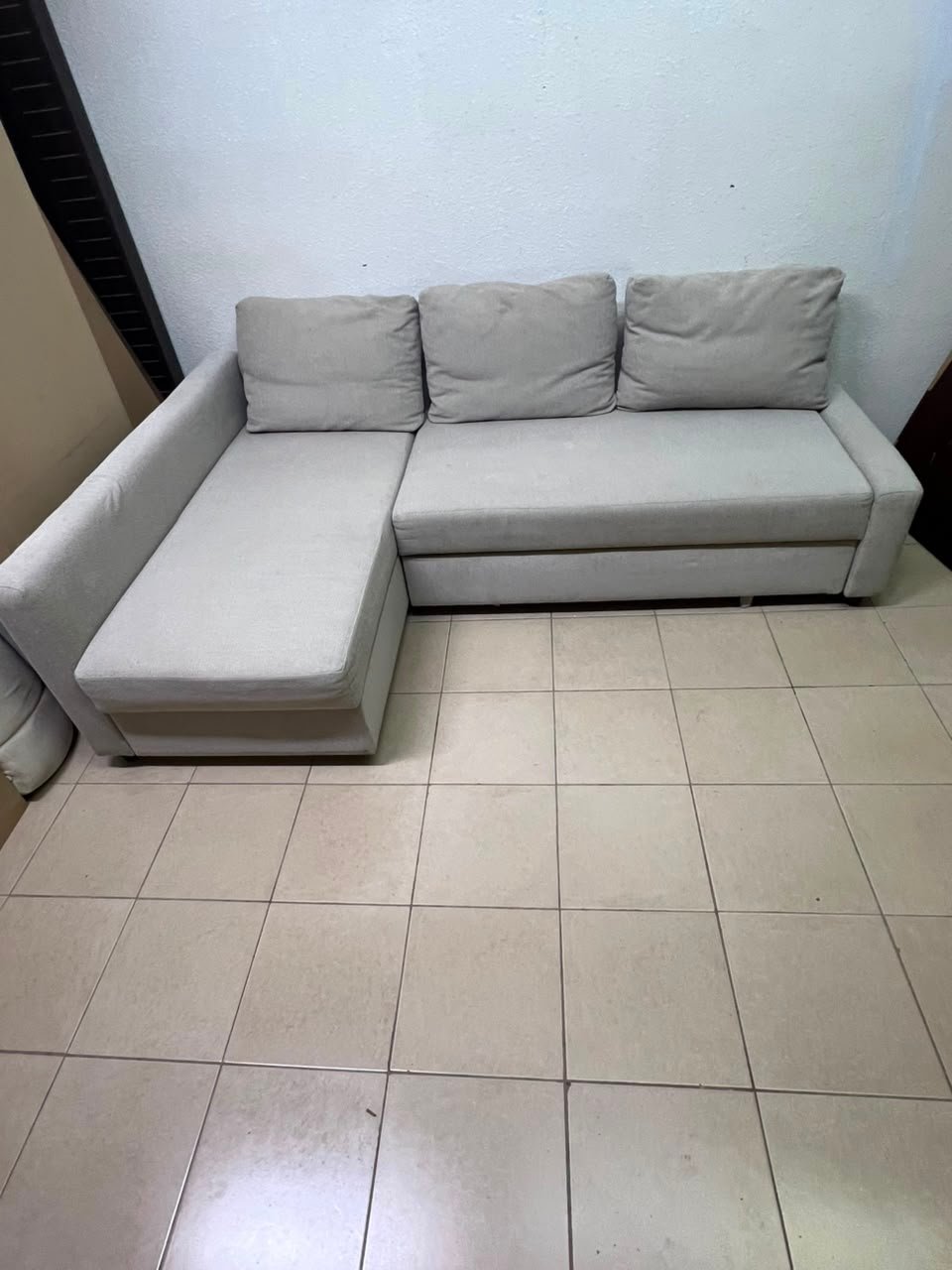 The IKEA FRIHETEN corner sofa that converts into a bed features a light gray color and a practical design that includes storage space. - Image 10