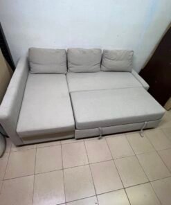 The IKEA FRIHETEN corner sofa that converts into a bed features a light gray color and a practical design that includes storage space. - Image 11