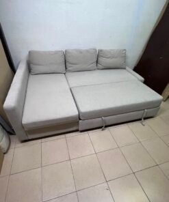 The IKEA FRIHETEN corner sofa that converts into a bed features a light gray color and a practical design that includes storage space. - Image 12
