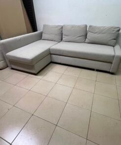 The IKEA FRIHETEN corner sofa that converts into a bed features a light gray color and a practical design that includes storage space. - Image 3