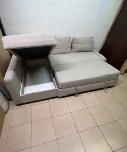 The IKEA FRIHETEN corner sofa that converts into a bed features a light gray color and a practical design that includes storage space. - Image 4