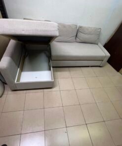 The IKEA FRIHETEN corner sofa that converts into a bed features a light gray color and a practical design that includes storage space. - Image 5