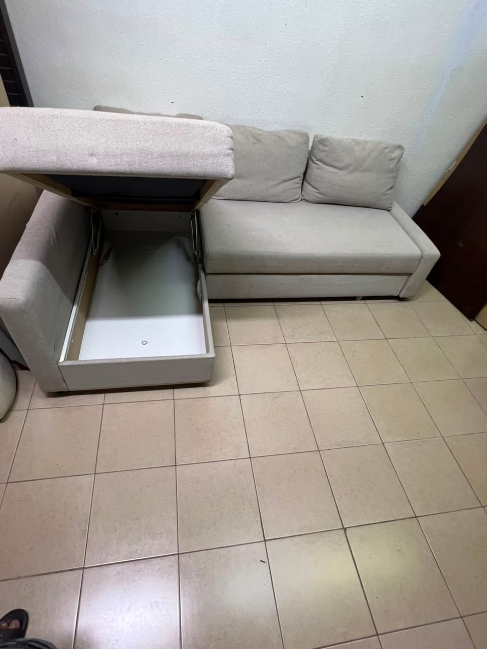 The IKEA FRIHETEN corner sofa that converts into a bed features a light gray color and a practical design that includes storage space. - Image 5