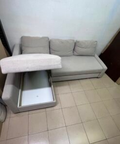 The IKEA FRIHETEN corner sofa that converts into a bed features a light gray color and a practical design that includes storage space. - Image 6