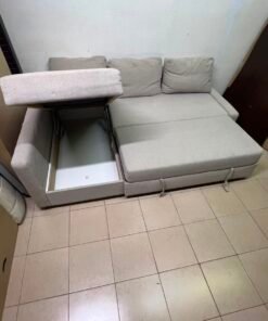 The IKEA FRIHETEN corner sofa that converts into a bed features a light gray color and a practical design that includes storage space. - Image 7