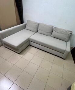 The IKEA FRIHETEN corner sofa that converts into a bed features a light gray color and a practical design that includes storage space. - Image 8