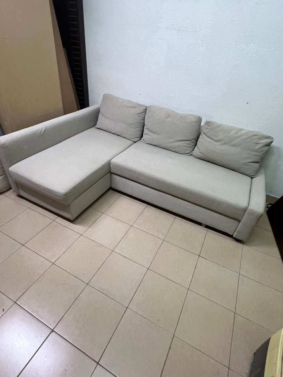 The IKEA FRIHETEN corner sofa that converts into a bed features a light gray color and a practical design that includes storage space. - Image 8