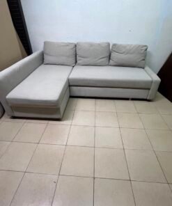 The IKEA FRIHETEN corner sofa that converts into a bed features a light gray color and a practical design that includes storage space. - Image 9