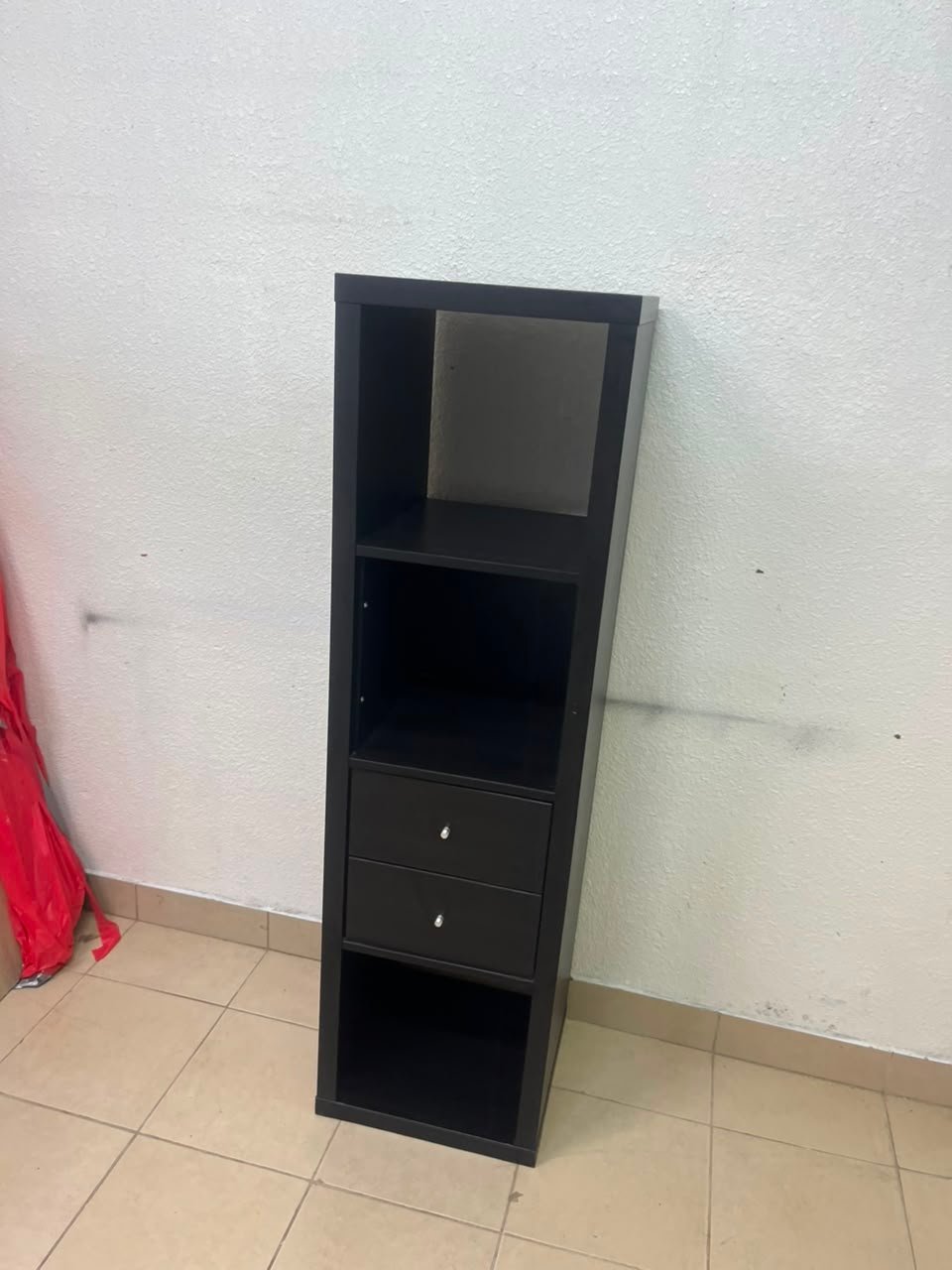 The IKEA KALLAX shelving unit, in black and brown, features a vertical design with built-in drawer units. - Image 2