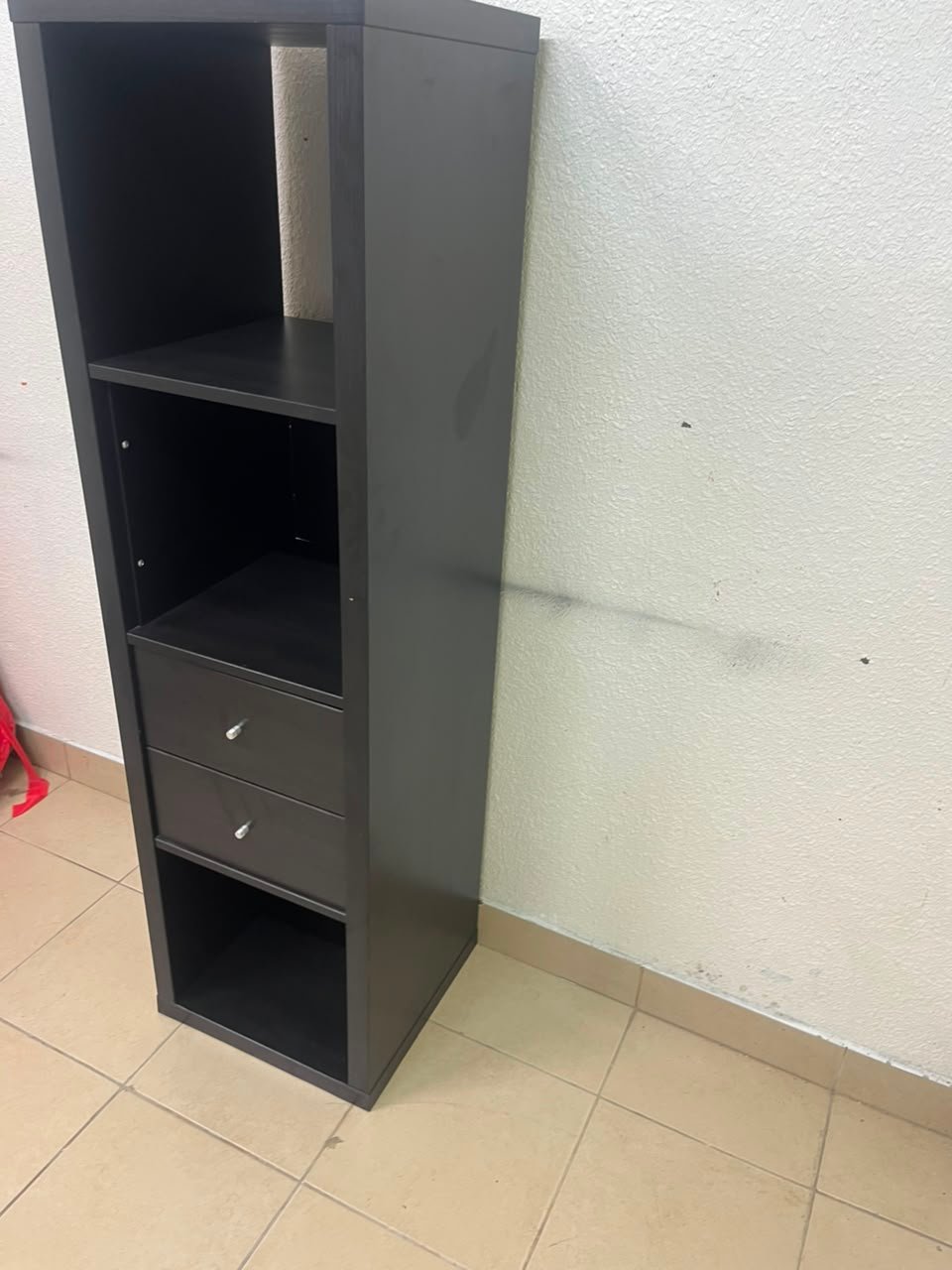 The IKEA KALLAX shelving unit, in black and brown, features a vertical design with built-in drawer units. - Image 3
