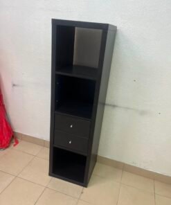 The IKEA KALLAX shelving unit, in black and brown, features a vertical design with built-in drawer units.
