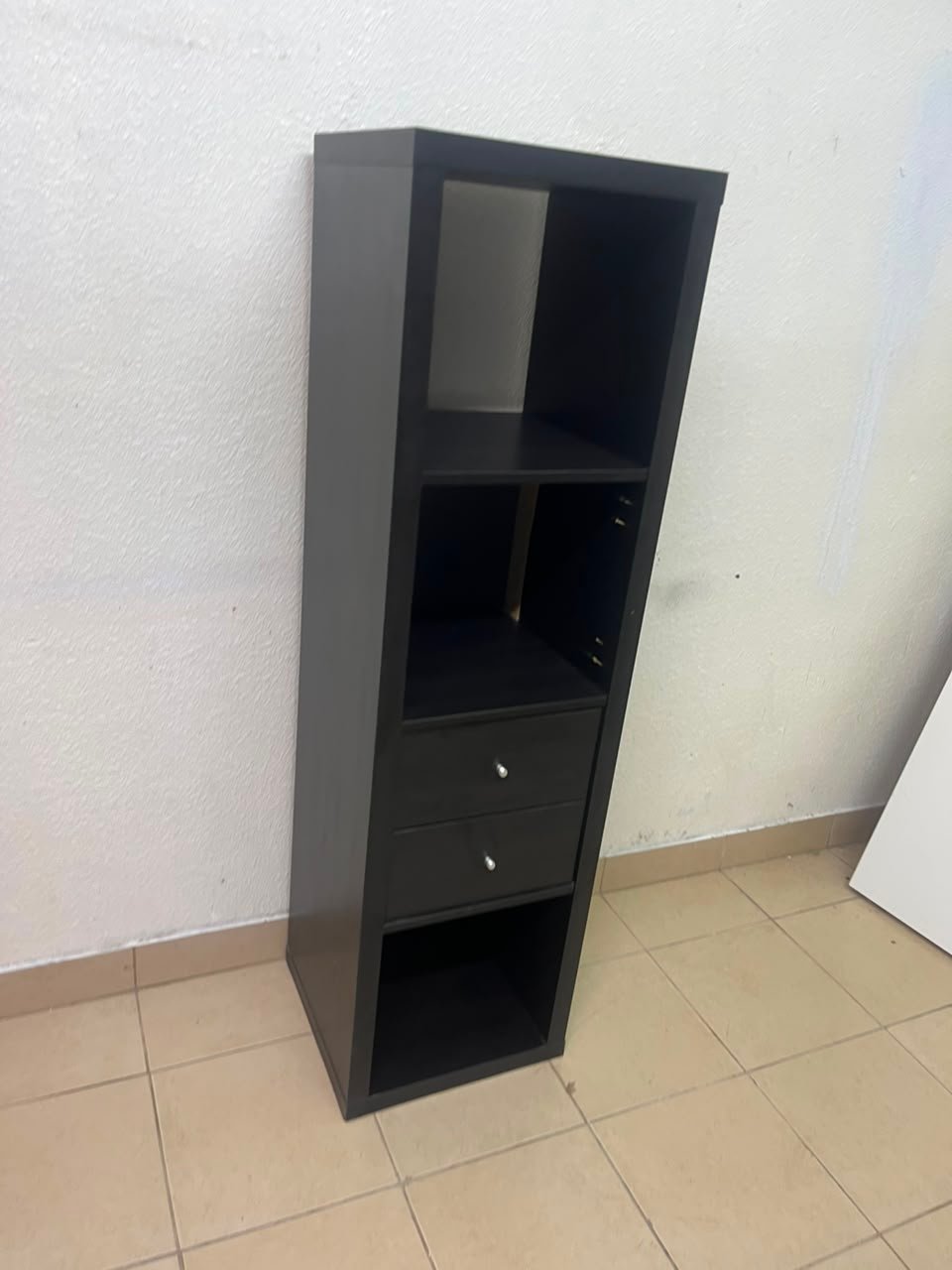 The IKEA KALLAX shelving unit, in black and brown, features a vertical design with built-in drawer units. - Image 5