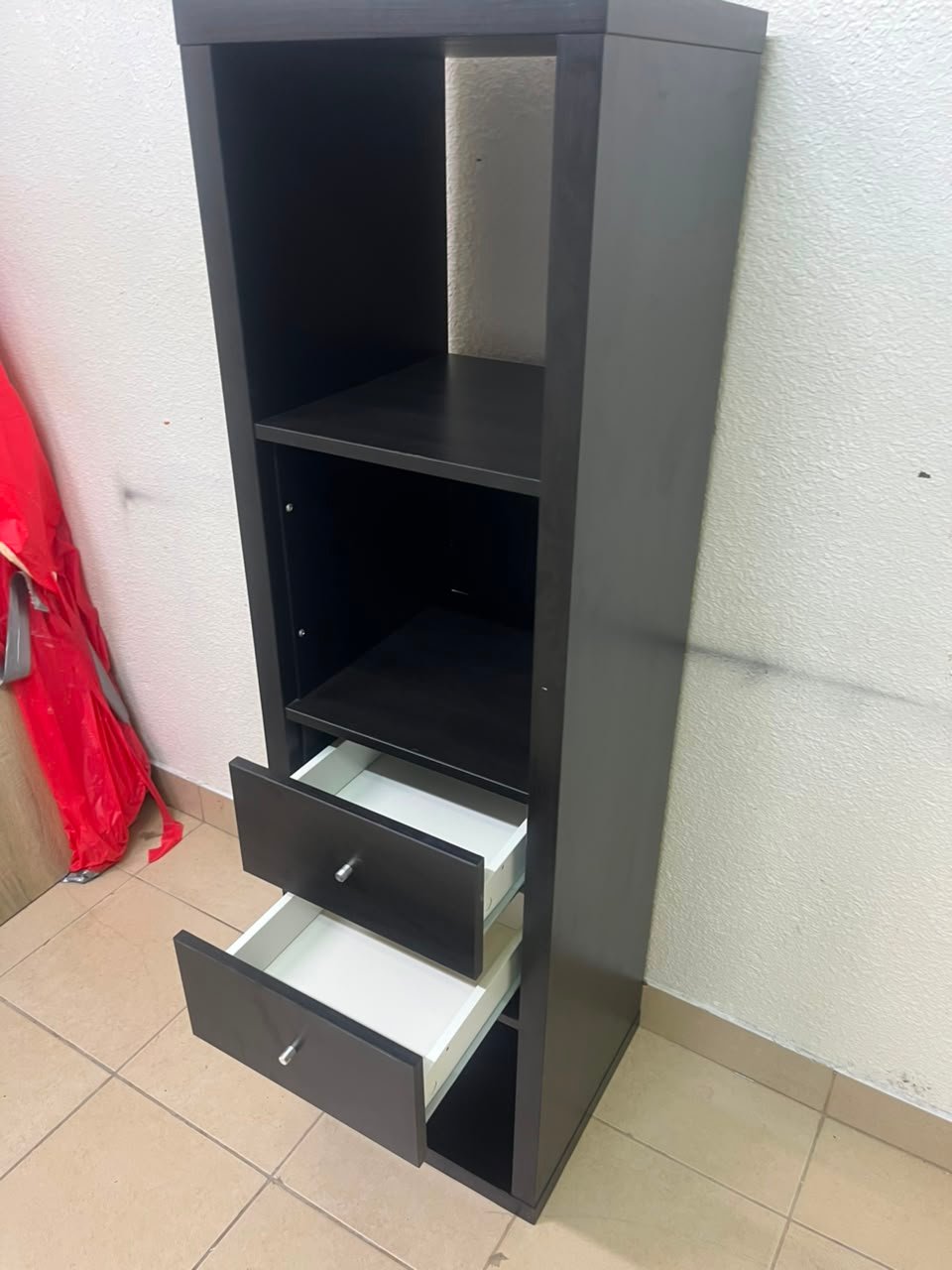 The IKEA KALLAX shelving unit, in black and brown, features a vertical design with built-in drawer units. - Image 6