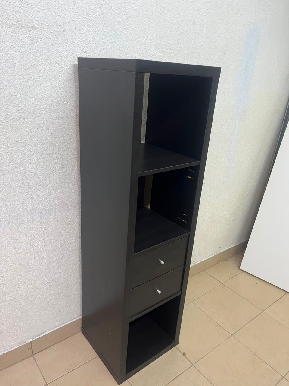 The IKEA KALLAX shelving unit, in black and brown, features a vertical design with built-in drawer units. - Image 8