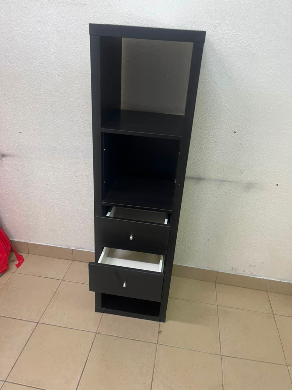 The IKEA KALLAX shelving unit, in black and brown, features a vertical design with built-in drawer units. - Image 9