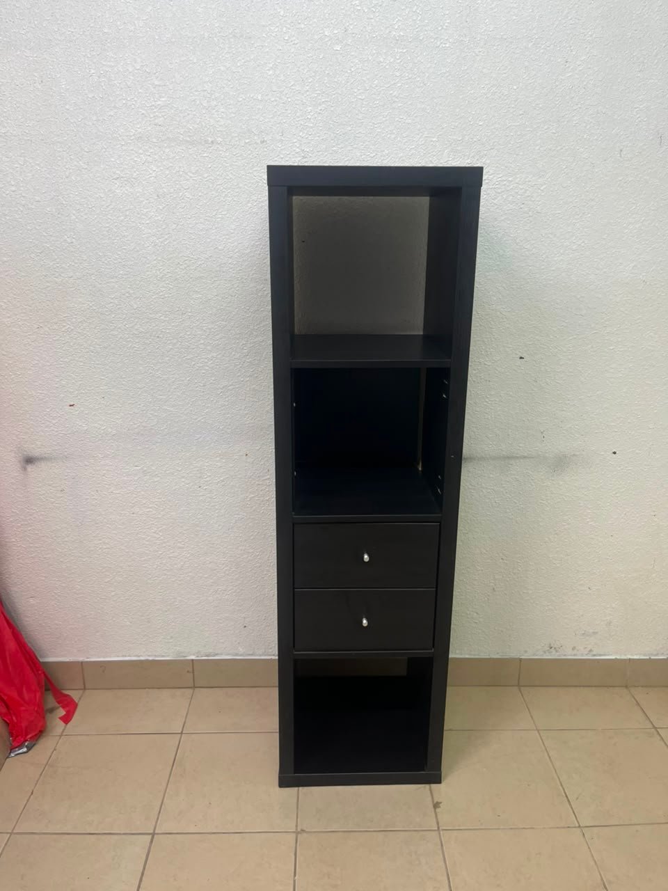 The IKEA KALLAX shelving unit, in black and brown, features a vertical design with built-in drawer units. - Image 10