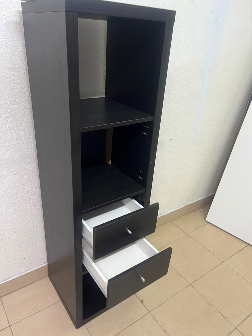 The IKEA KALLAX shelving unit, in black and brown, features a vertical design with built-in drawer units. - Image 11