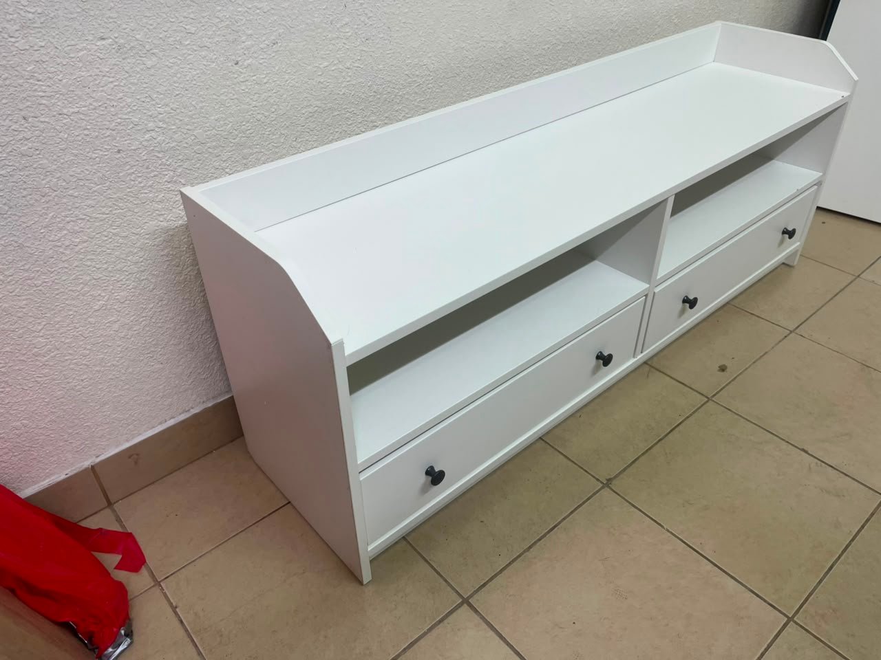 The IKEA HAUGA TV stand in white features a classic design with two drawers and open spaces. - Image 2