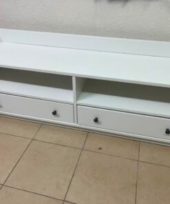 The IKEA HAUGA TV stand in white features a classic design with two drawers and open spaces.