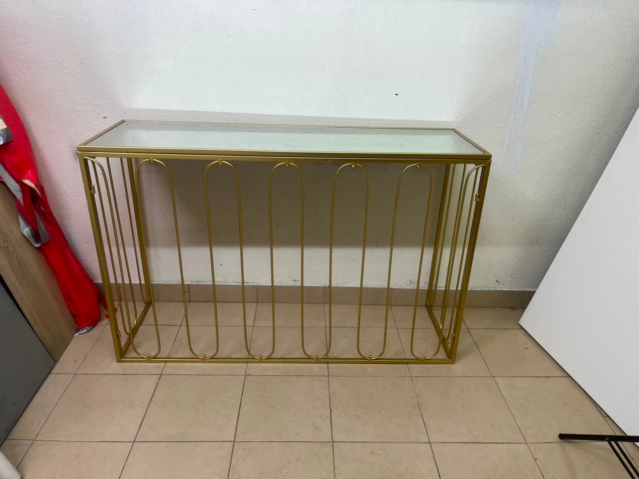Modern console table with a gold metal frame and reflective glass top - Image 13