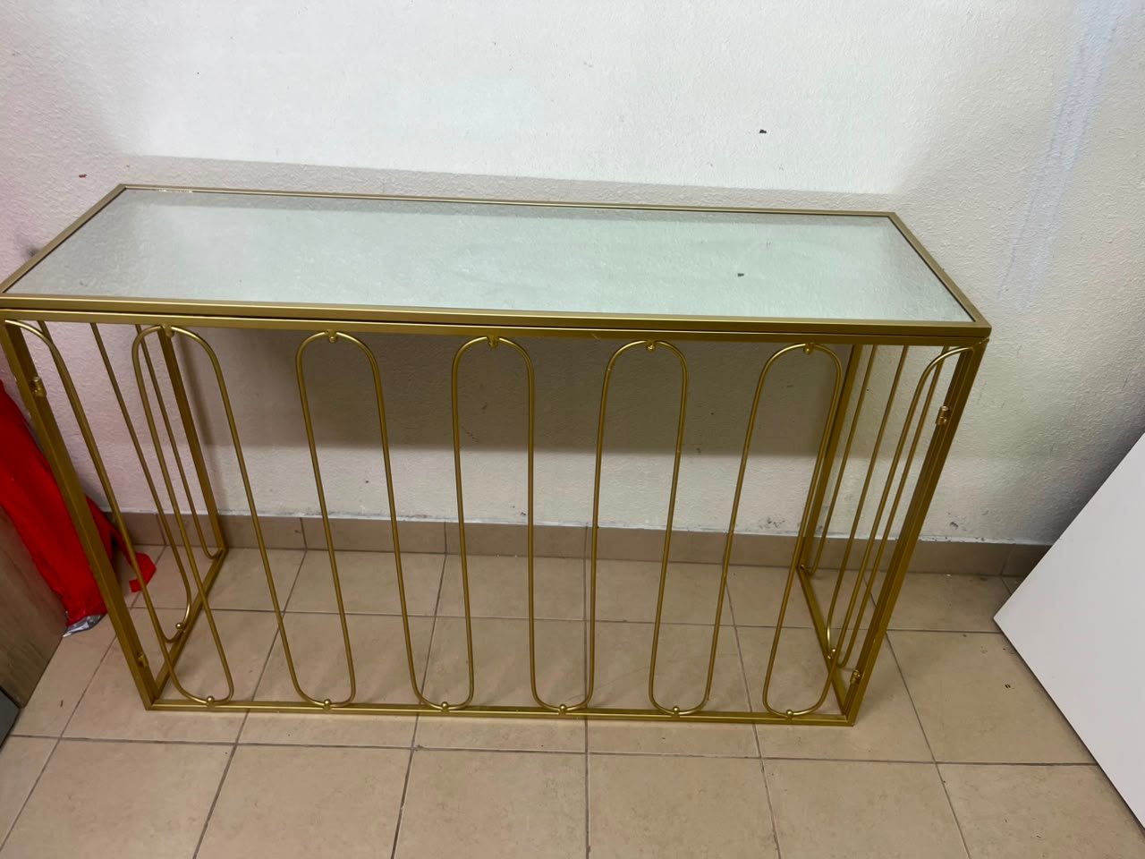 Modern console table with a gold metal frame and reflective glass top - Image 12