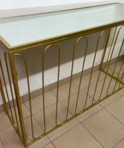 Modern console table with a gold metal frame and reflective glass top - Image 3