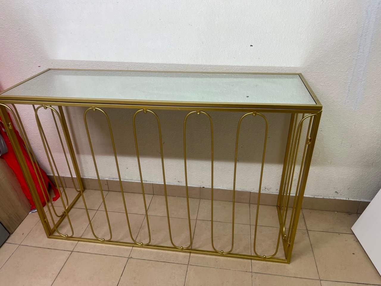 Modern console table with a gold metal frame and reflective glass top - Image 7