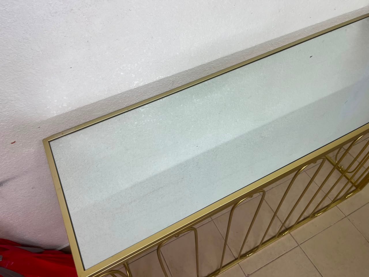 Modern console table with a gold metal frame and reflective glass top - Image 10