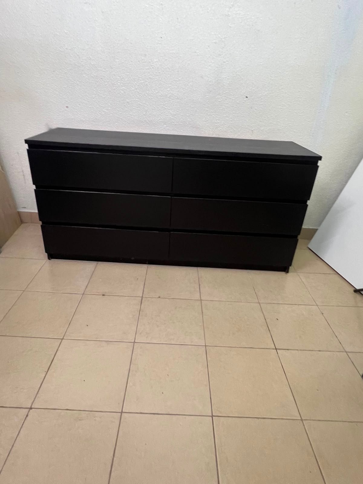 The MALM chest of drawers from IKEA, in black and brown, features a simple and modern design. - Image 3