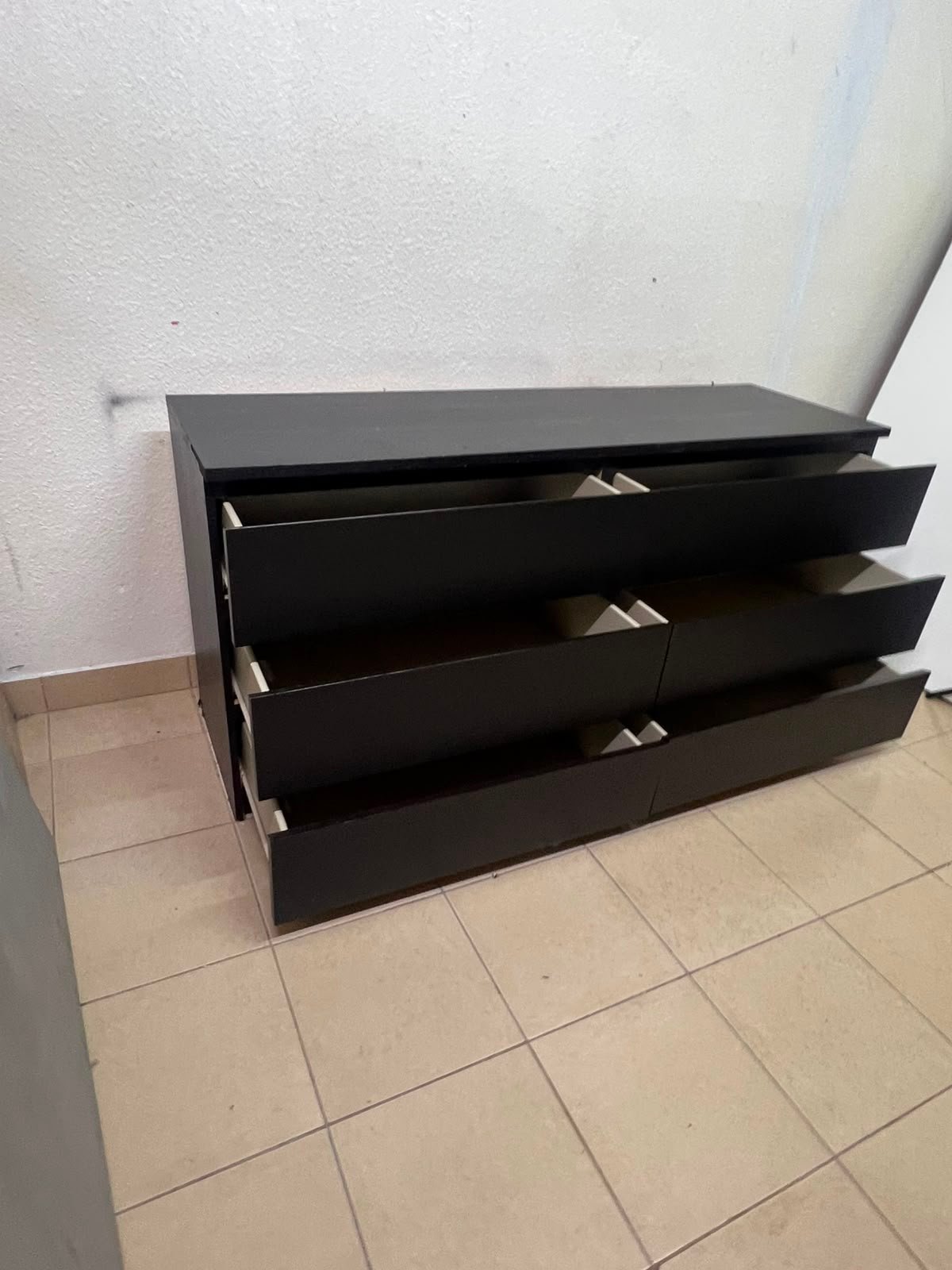 The MALM chest of drawers from IKEA, in black and brown, features a simple and modern design. - Image 11