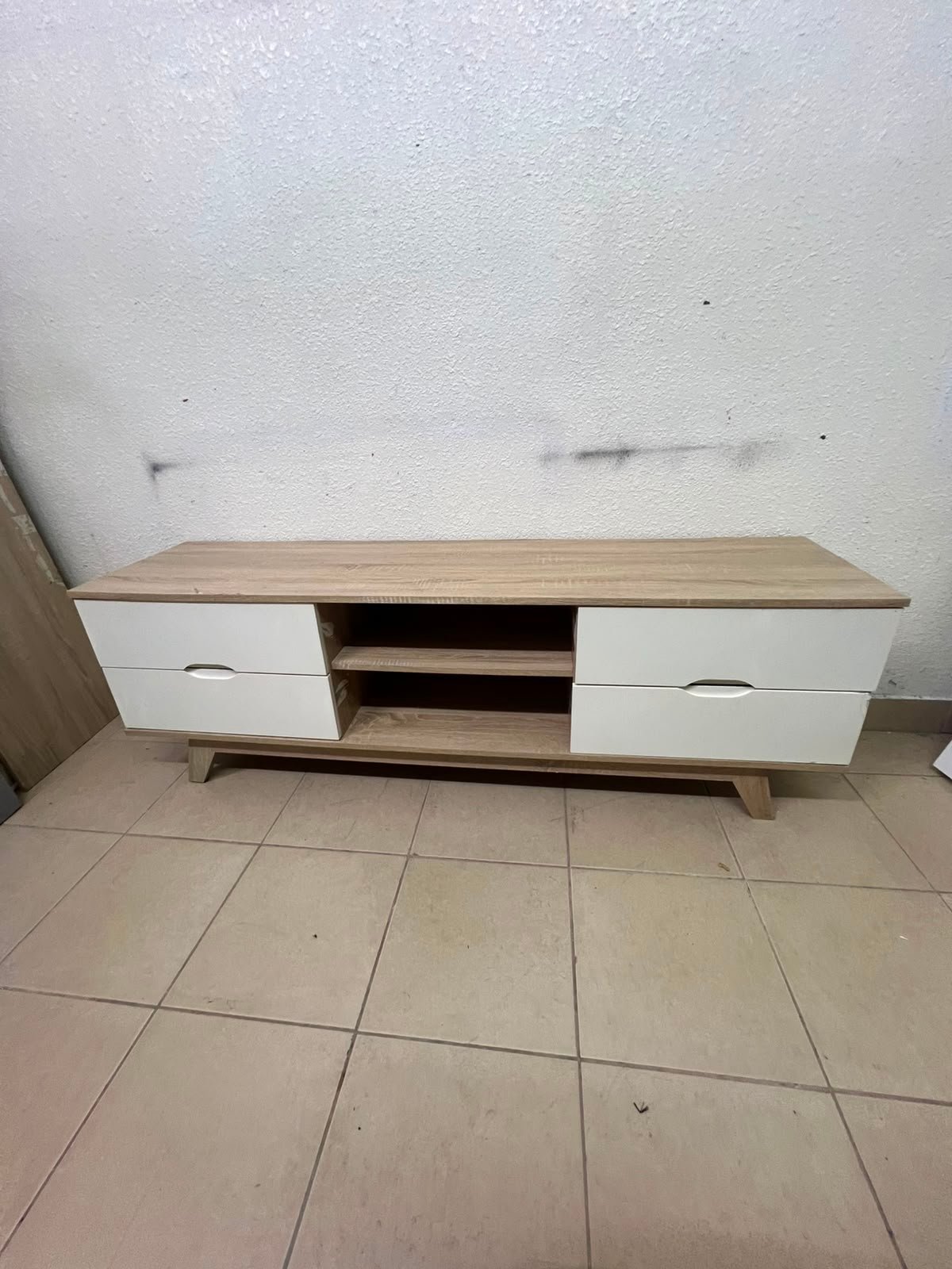 The Lucid TV unit from Home Centre features a simple geometric wood design with white drawers.