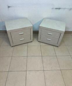 A beige upholstered nightstand with two drawers and silver handles. - Image 7