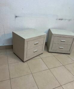 A beige upholstered nightstand with two drawers and silver handles. - Image 8