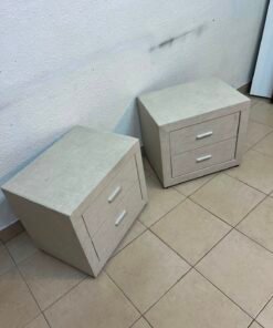 A beige upholstered nightstand with two drawers and silver handles. - Image 4