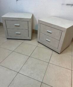 A beige upholstered nightstand with two drawers and silver handles. - Image 5
