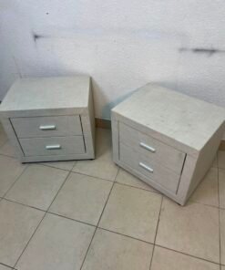 A beige upholstered nightstand with two drawers and silver handles. - Image 9