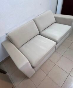 The KIVIK two-seater sofa is beige and features wide, low armrests. - Image 3