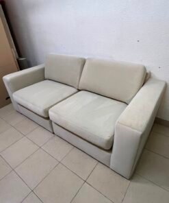 The KIVIK two-seater sofa is beige and features wide, low armrests. - Image 10